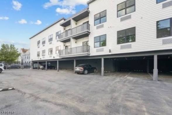 View along the residential building and covered parking at Coral View Luxe Apartments. View along the residential building and covered parking at Coral View Luxe Apartments.